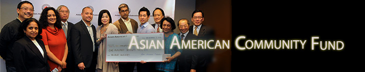 People Holding a Large Check